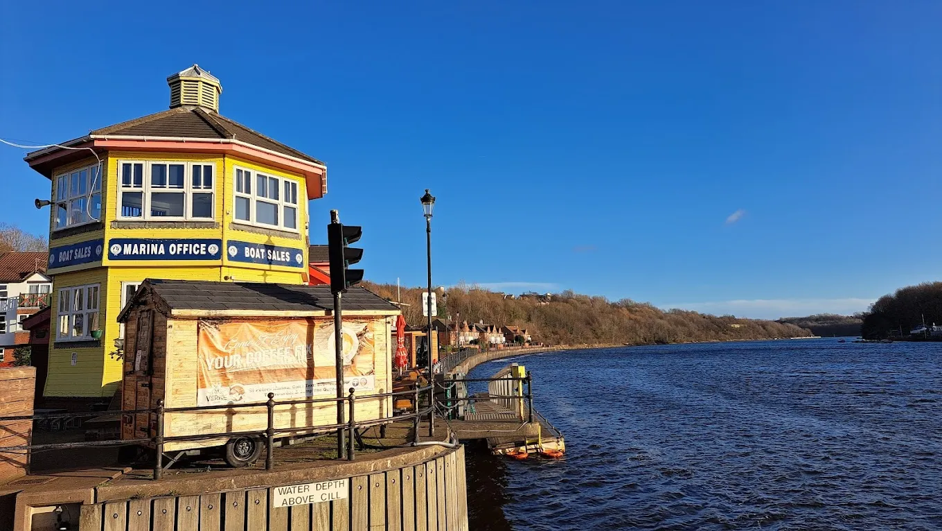 The yellow St Peters Marina office beside the River Tyne